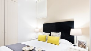 A neatly arranged bedroom with a bed, bedside tables, and a wardrobe. - CARRETAS APARTMENTS MADRID 102 (MADRID)