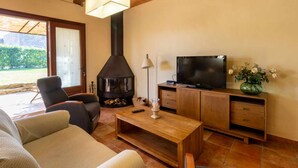 A cozy living room with a fireplace, a television, and comfortable seating. - RURAL HOUSE IN THE COSTA BRAVA (Sant Feliu De Boada)