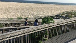 A wooden boardwalk leading to a sandy beach with a clear view of the ocean. - Cozy 2 BR Apt in historic Cape May, NJ (Cape May)