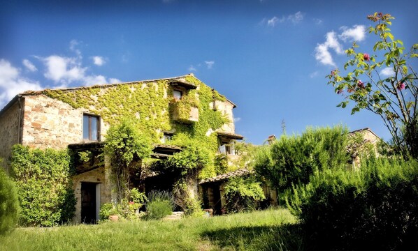 An old stone building with ivy-covered walls and a rustic appearance.