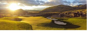 A golf course with rolling green hills, a pond, and a town in the background. - Ski-In Ski-Out 1-Bedroom Luxury Condo at Park City Canyons (Park City)