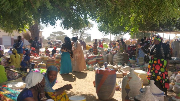 A bustling outdoor market with people and colorful woven baskets. - BEAUTIFUL VILLA WITH SWIMMING POOL, RESIDENCE "SAFARI VILLAGE" WITH PRIVATE BEACH 100M (Unknown)