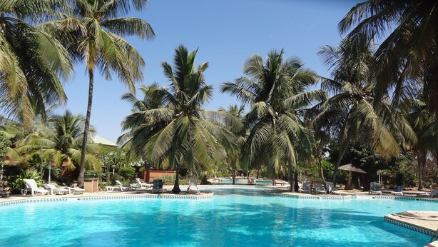 A swimming pool surrounded by palm trees and lounge chairs. - BEAUTIFUL VILLA WITH SWIMMING POOL, RESIDENCE "SAFARI VILLAGE" WITH PRIVATE BEACH 100M (Unknown)