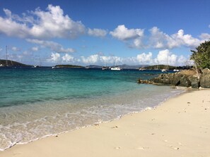 A beach with clear turquoise water, a sandy shore, and several sailboats anchored in the distance. - Paradise at the Westin St John Studio Villa, Amazing views, full resort access (Cruz Bay)