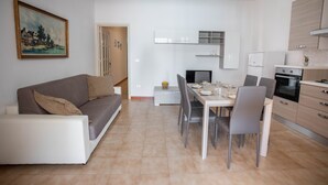 A modern apartment with a dining area, kitchen, and living space. - Apartment for rent with terrace (TL66A) (Torre Lapillo)