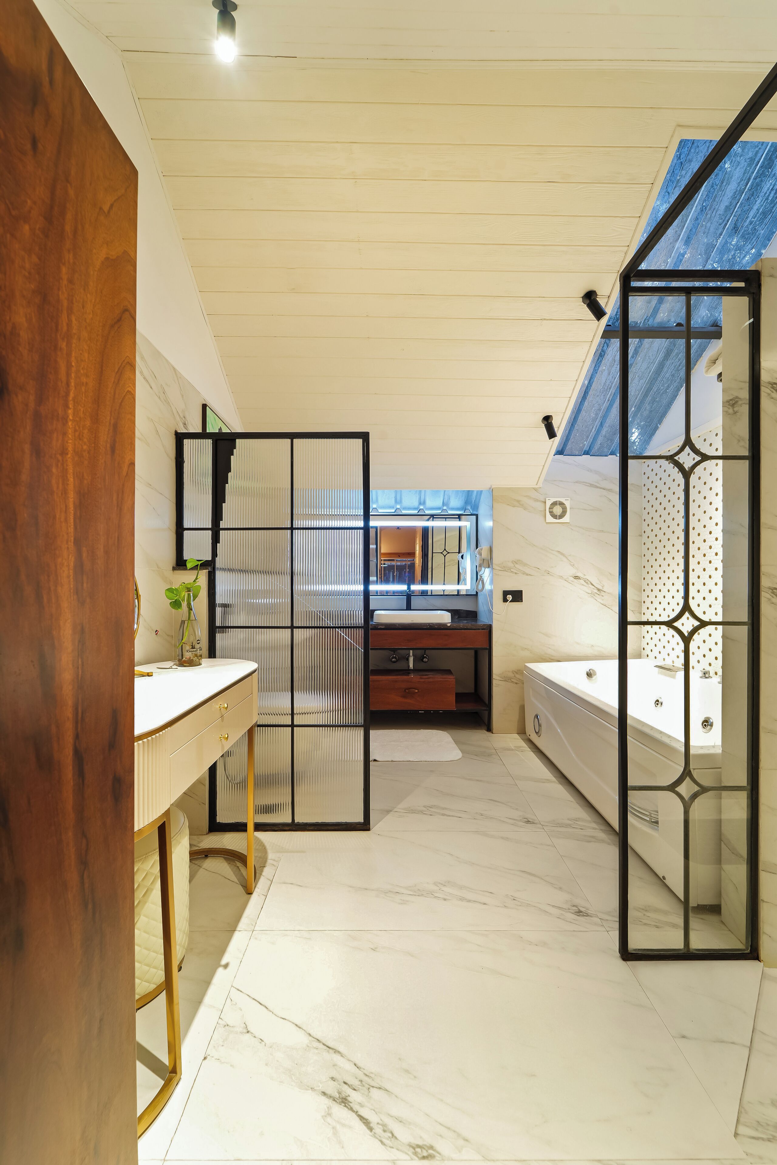 A modern bathroom with a wooden vanity, a bathtub, and a shower area.
