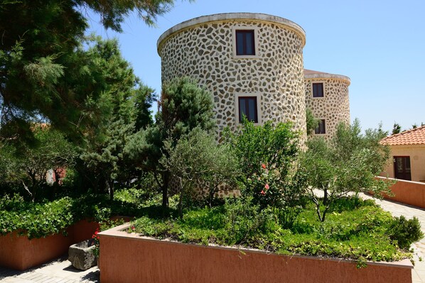 A building with a circular stone facade and multiple windows.