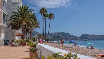 On the beach, sun-loungers