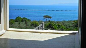 Una habitación con un gran ventanal con vistas a la costa.