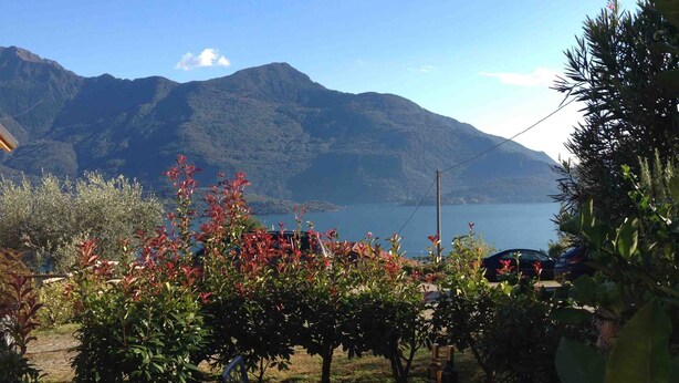 A table set outdoors with a view of a lake and mountains.