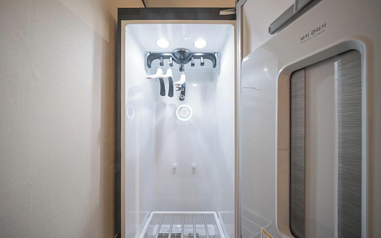 A compact, modern bathroom with a shower area, a toilet, and a sink.