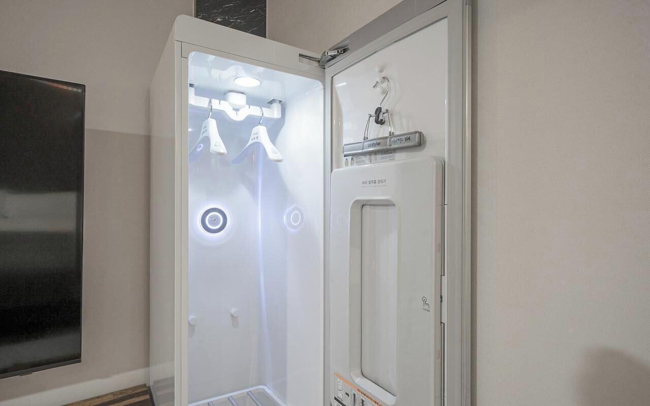 Un baño con ducha, inodoro y espejo.