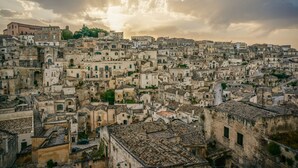 A densely packed urban area with historic buildings, narrow streets, and a prominent church spire. - La Tavernetta Apartment CIN IT077014C201874001 (MATERA)