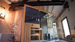 A modern bathroom with a glass enclosure, wooden accents, and a visible shower area. - Villa Verecondi Scortecci (Colle Umberto)