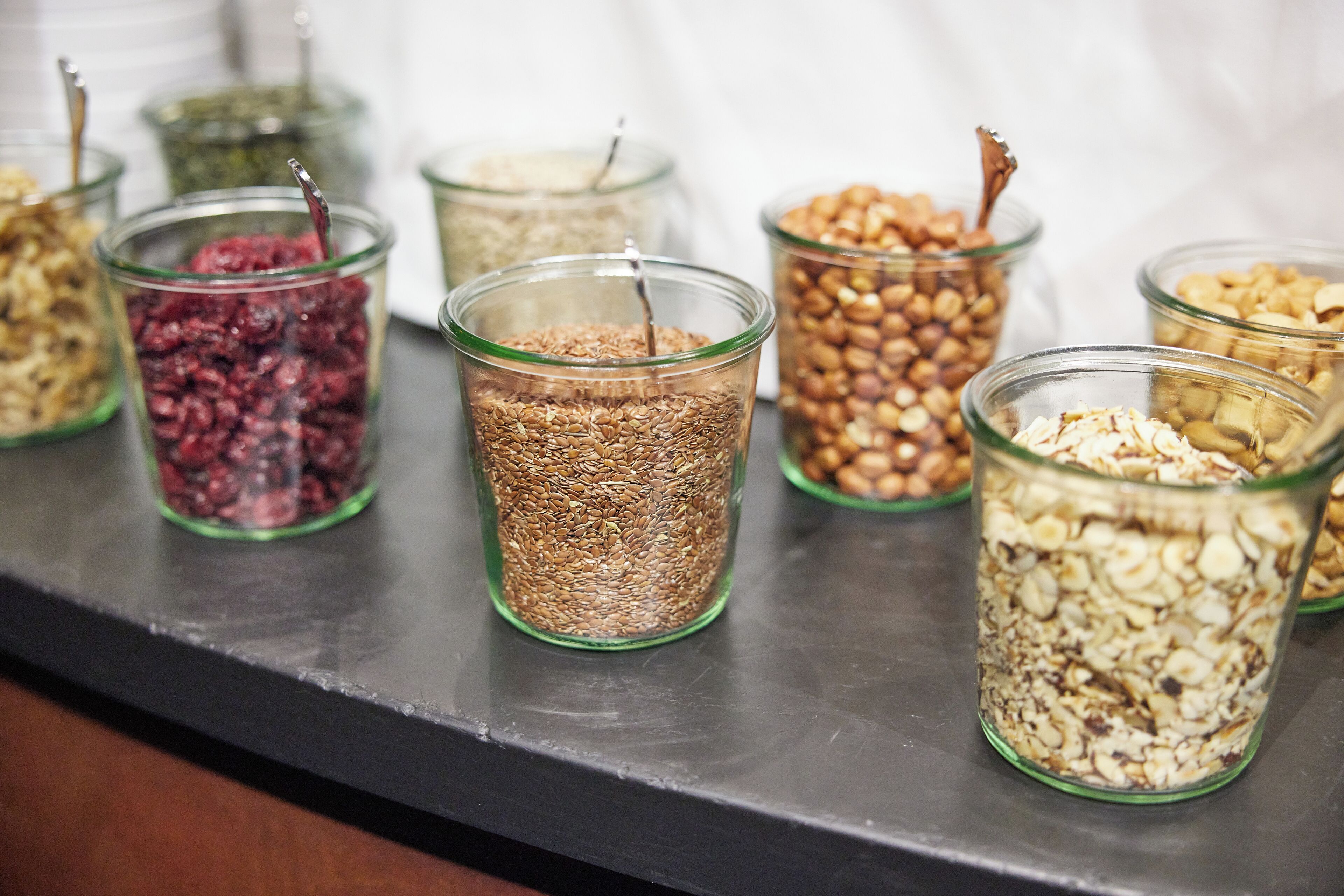 A variety of food items in glass containers on a counter.