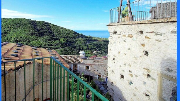 A balcony with a view of a coastal village and hills. - Calabria, Medieval Village, Ecotourism, tradition and culture, sea and nature. (Belmonte Calabro)