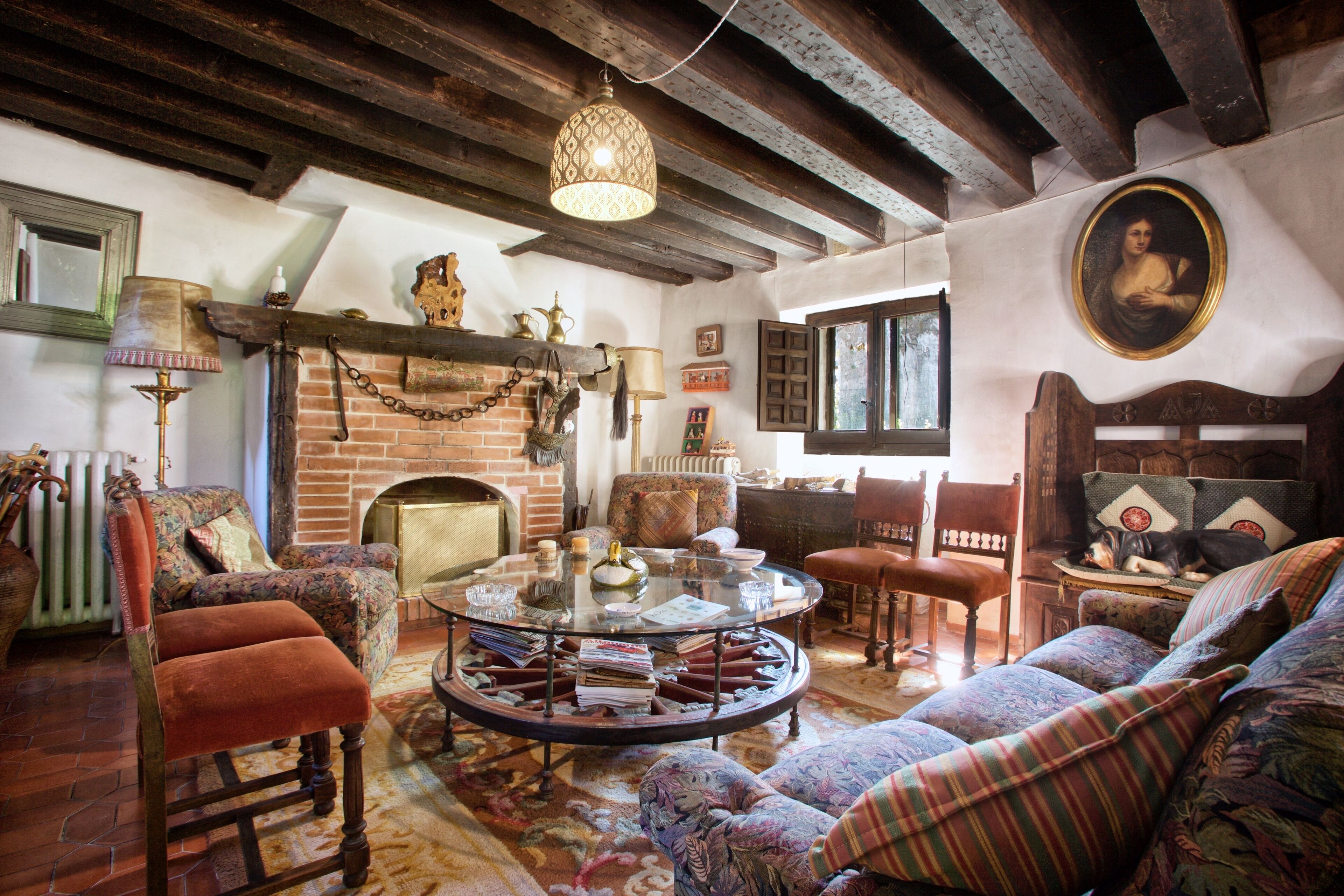 A cozy living room with a fireplace, a round coffee table, and comfortable seating.
