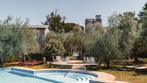 A swimming pool with lounge chairs and a stone pathway. - In a historic farmhouse in the hills, with garden and pool, perfect for families (Pesaro)