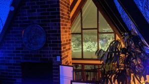 A building with a brick facade, large windows, and a decorative circular element on the wall. - ONE OF A KIND vacation rental with a view (Madison)