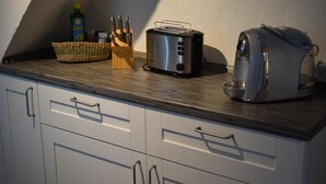 A kitchen with a toaster, a kettle, and a knife block on the counter. - Messewohnung Gräfrath (Solingen)
