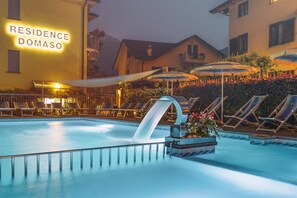 A swimming pool with lounge chairs and umbrellas, a water slide, and a sign reading 'RESIDENCE DOMASO'. - RESIDENCE DOMASO - TWO BEDROOM APARTMENT (DOMASO)