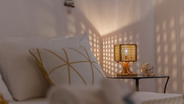 A bed with white bedding and a decorative pillow, a small table with a lamp, and a decorative globe. - Holiday house in Torre Lapillo beach (TL23) (Torre Lapillo)
