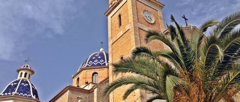 A historic building with a prominent clock tower and domed structures.