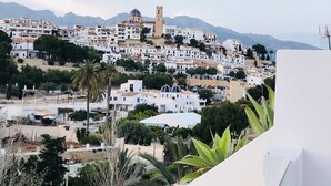A coastal town with white buildings, a prominent church with a bell tower, and mountains in the background. - Luxurious Penthouse (Atico) ‘La Mar Altea', max. 4p (Altea)