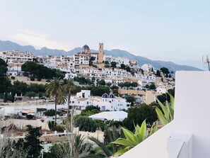 Perched on a hillside, the historic church stands tall amidst a charming coastal town with a mix of architectural styles.