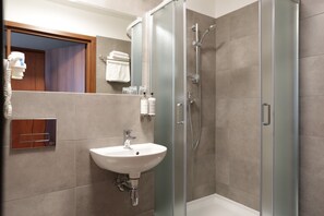 Shower, designer toiletries, hair dryer, towels