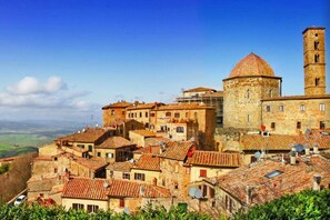 A historic town with traditional architecture, including a prominent tower and a dome.