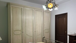 A bedroom with a bed, a wardrobe, a nightstand, and a door. - Villa BUTTERFLY 1 SEA RELAX AND CLOSE TO CULTURAL SITES (Capaci)