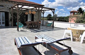 A rooftop patio with a pergola, outdoor furniture, and a view of the surrounding landscape. - Historic residence with spectacular views, between Perugia and Assisi (Sant'Egidio)