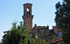 A historic tower with a bell, surrounded by traditional buildings with tiled roofs. - Historic residence with spectacular views, between Perugia and Assisi (Sant'Egidio)
