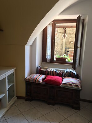 Relax in a quiet reading nook with a bench and a view of the surrounding garden.