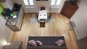 A compact living space with a kitchenette, dining area, and seating area. - "GIADA" - Elegant Penthouse for 4 people on the 3rd floor on 2 levels (Firenze)