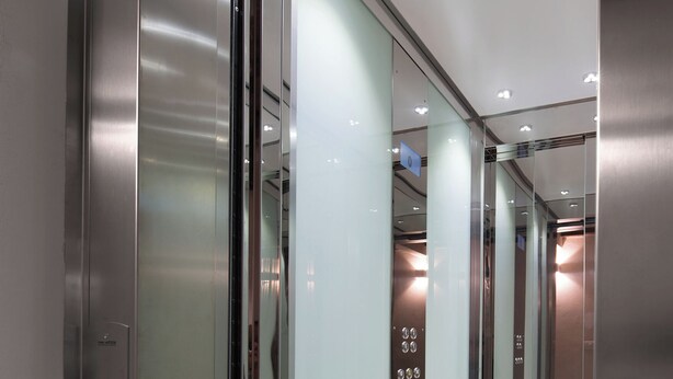 An elevator interior with glass doors, a metallic finish, and a wooden floor. - "GIADA" - Elegant Penthouse for 4 people on the 3rd floor on 2 levels (Firenze)