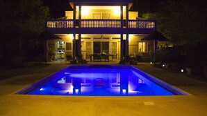 A two-story building with a swimming pool in front. - Somone: large air-conditioned villa with swimming pool, 10 people *, between Sea and Lagoon (Unknown)