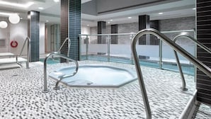 A modern indoor pool with a tiled floor, metal railings, and a bench. - 2-Bed, 2-Bath Condo w/Pool & Parking by Square 1 (Mississauga)