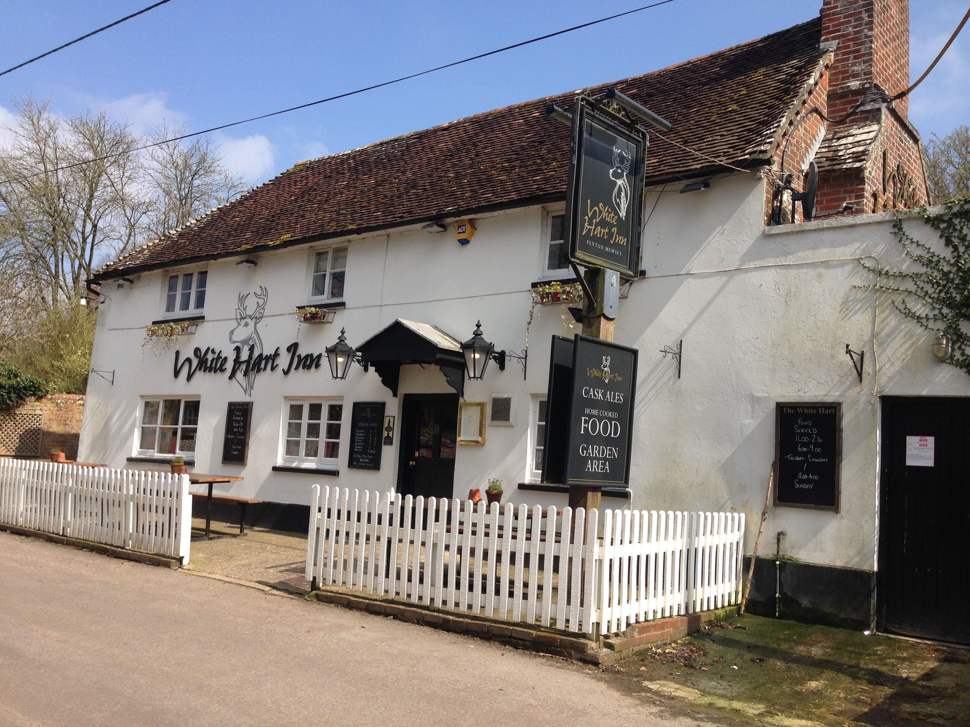 A traditional white building with a sign reading "White Hart Inn".