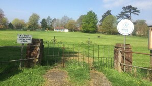 A cricket ground entrance with a sign prohibiting dogs and a welcome sign for the Penton Cricket Club. - Chalkcroft lodge (Andover)