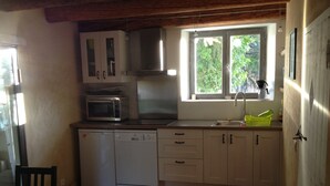 A compact kitchen with a dishwasher, microwave, and sink. - Les Mûriers: 55m2 gite for 2/4 people in a quiet location overlooking the Luberon and vineyards (Gargas)