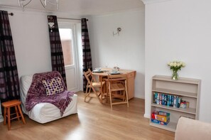 Three-Bedroom House | Living area | Flat-screen TV