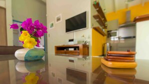 A modern kitchen with a flat-screen TV mounted on the wall, a wooden cabinet, and a kitchen counter. - Treat yourself to a dream vacation! (Petit Bourg)