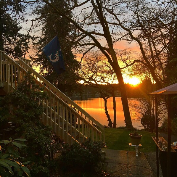 A wooden staircase leading to a gazebo overlooking a lake at sunset. - 1-bedroom Lakefront vacation Unit just 13 minutes from Tacoma Dome (Tacoma)