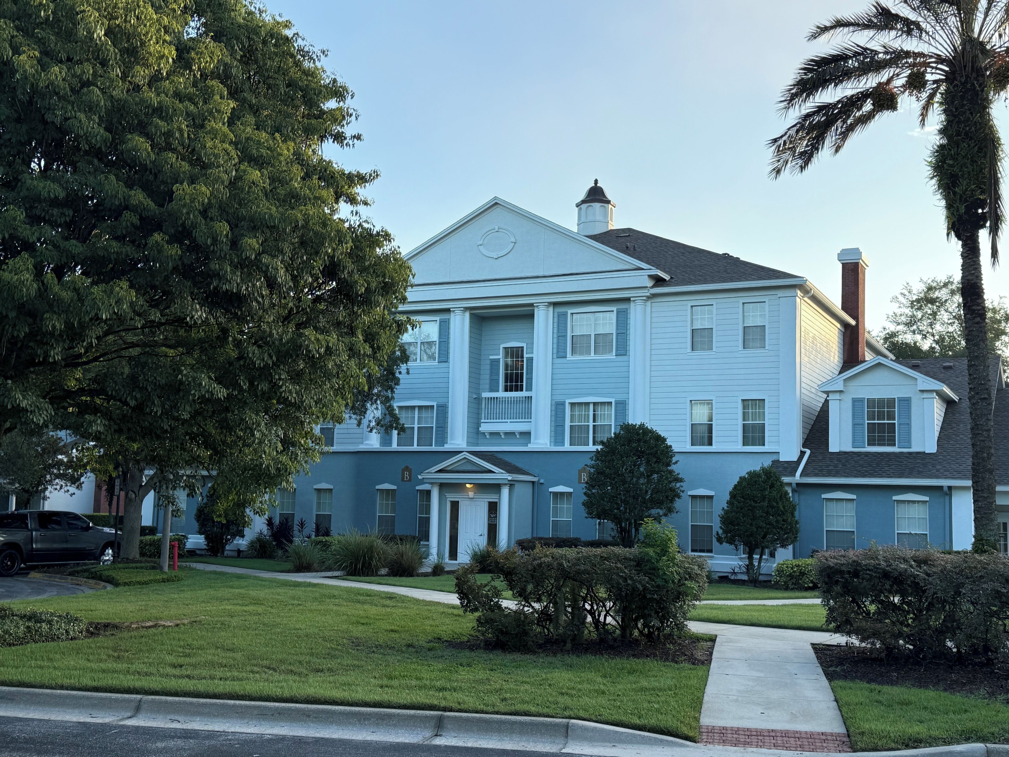 A two-story house with a front porch, a garage, and a driveway.
