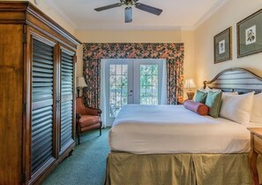Relax in comfort with a large bed, wooden headboard, and stylish furniture.