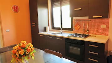 Oven, coffee/tea maker, cookware/dishes/utensils, dining tables