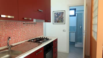 Oven, coffee/tea maker, cookware/dishes/utensils, dining tables