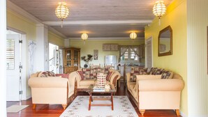 A living room with two sofas, a coffee table, and a chandelier.
